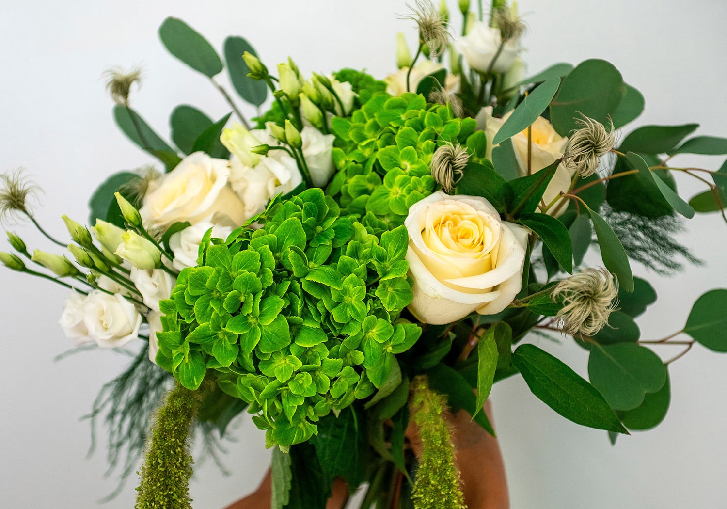 Fresh green and white bouquet with hydrangea and roses, hand-tied for a natural spring look.